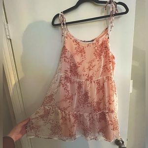 Light pink floral dress. Sheer top layer with a pink slip that’s connected.
